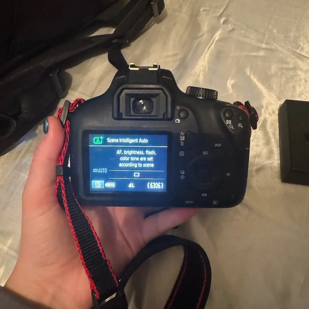 CANON EOS Rebel t100 with 18-55mm lens and another lens.